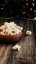 Popcorn in a wooden plate on the background of