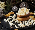 Popcorn in a wooden plate on the background of Christmas