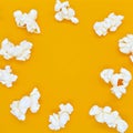 Popcorn on yellow background photo frame. Top view.