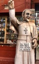 A Pope statue wearing a cross