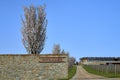 Blooming fruit tree behind the fence, vinary and road leading to wooden house with big windows Royalty Free Stock Photo