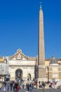 Popolo square, obelisk in evidence, countless people circulating in the Italian city of Rome.