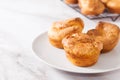 Popovers or Yorkshire pudding on a white plate on a white background, appetizer, breakfast Royalty Free Stock Photo