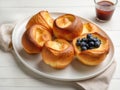 Popovers or Yorkshire Puddings with berries on white plate. Tasty healthy breakfast. Generative AI Royalty Free Stock Photo