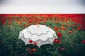 Poppies field with umbrella. Artistic interpretation