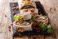 Poppy beigli cake with raisins, walnuts decorated with icing and mint close-up on a table. horizontal Royalty Free Stock Photo