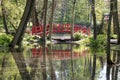A poppy bridge in a park over the water