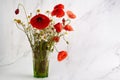 Poppy and daisy wild flowers bouquet on marble background. Floral background. Royalty Free Stock Photo