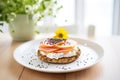 poppy seed bagel with cream cheese on a glass plate Royalty Free Stock Photo