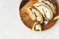 Poppy seed roll or strudel on wooden board sprinkled with powdered sugar. Royalty Free Stock Photo
