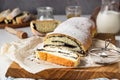 Poppy seed roll or strudel on wooden board sprinkled with powdered sugar. Royalty Free Stock Photo