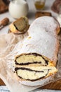 Poppy seed roll or strudel on wooden board sprinkled with powdered sugar. Royalty Free Stock Photo