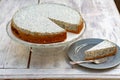 Poppy seeds Cheesecake with piece on plate and fork on wood table