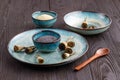 Poppy seeds and seedpods in ceramic bowl