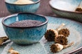 Poppy seeds and seedpods in ceramic bowl