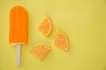 Popsicle with fresh orange on a table Royalty Free Stock Photo