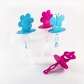 Popsicle molds on white background