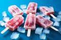 Popsicles and ice cubes arranged on a blue background from above Royalty Free Stock Photo
