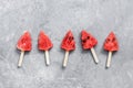 Popsicles on a stick of watermelon in the shape of a Christmas tree on a gray rustic background. Top view, flat lay