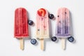 Variety of berry flavors of popsicles overhead view on white background, generative AI Royalty Free Stock Photo