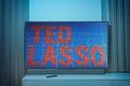 Popular apple tv show on television screen TED LASSO Royalty Free Stock Photo