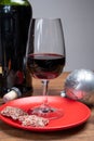 Popular british christmas drink, glass of vintage ruby port wine and christmas tree decoration