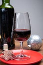 Popular british christmas drink, glass of vintage ruby port wine and christmas tree decoration