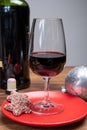 Popular british christmas drink, glass of vintage ruby port wine and christmas tree decoration