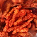 Flaming Hot Crunchy Cheese Puffs. Square format. Royalty Free Stock Photo