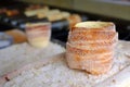 A popular dish among tourists traditional Czech food `Trdelnik` to prepared on a wooden skewers over hot coals