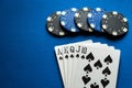 A popular and exciting poker game with a winning combination of royal flush. Playing cards and chips on a blue table in a poker Royalty Free Stock Photo