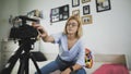 Popular female blogger is turning on the camera and strating recording video