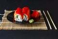 popular food. sushi, pickled ginger on a black plate on black concrete background. Sushi chopsticks Royalty Free Stock Photo