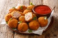 Popular fried hot appetizer sauerkraut balls stuffed with ham served with ketchup close-up in a plate. horizontal Royalty Free Stock Photo