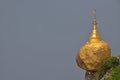 Popular Golden Rock in Myanmar with grey sky (space) on the left can be used by designer for message