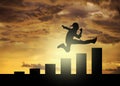 Popular guy running and jumping above a chart bar on the beech at sunset time. careen success and personal Improvement