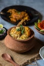 Popular Indian mughlai delicacy chicken biryani in an earthen pot with use of selective focus. Royalty Free Stock Photo