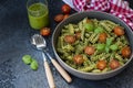 Fuzzily Italian pasta with pesto on black concrete background. Royalty Free Stock Photo