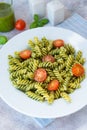 Fuzzily Italian pasta with pesto on light concrete background. Royalty Free Stock Photo