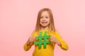 Popular kids content. Portrait of joyful cute adorable little girl holding hashtag symbol and looking at camera with toothy smile