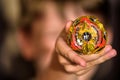 Popular kids toys. Little caucasian boy demonstrated Beyblade