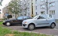 Small and big old veteran cars Fiat Seicento and Mercedes Benz S320 limo parked