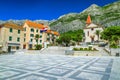 Mediterranean old city center with church and street cafees, Makarska