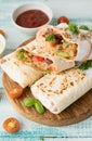 Popular Mexican food, burritos. Burrito with vegetables, red beans and hot sauce.