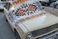 Armenia, Yerevan, September 2021. A vintage car covered with an old carpet.
