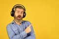 Popular music playlist. Music beat. Noise cancelling function. Dj hipster. Man bearded hipster headphones listening