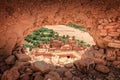 Popular point of view of the valley of the desolating river Onila through a hole in a wall of Ancient Kasbah in Ait-Ben Royalty Free Stock Photo