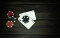 Popular poker game. Playing cards with a winning combination of two aces on a dark vintage table. Luck in playing cards depends on