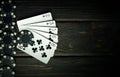 A popular poker game with a winning straight flush combination. Playing cards with chips on a black vintage table in a poker club