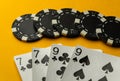 Popular poker game with winning two pairs. Chips and cards on a yellow table